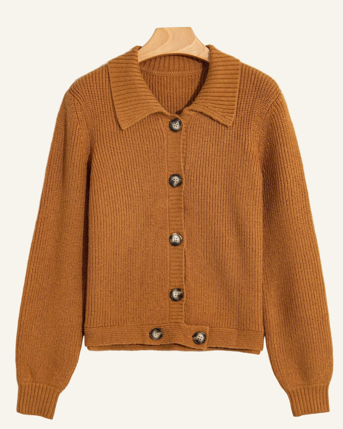 A ribbed knit cardigan sweater in a warm camel brown color, featuring a pointed collar and dark brown buttons.