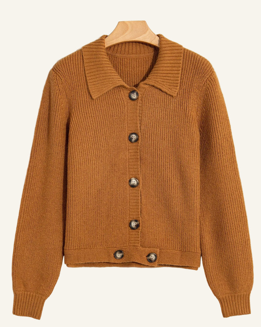 A ribbed knit cardigan sweater in a warm camel brown color, featuring a pointed collar and dark brown buttons.