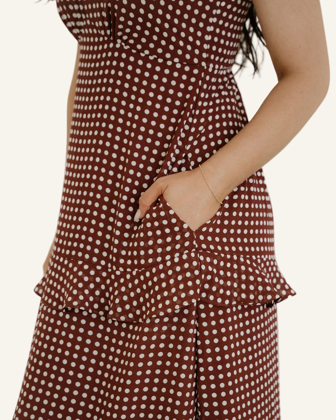 Person wearing a brown polka dot dress