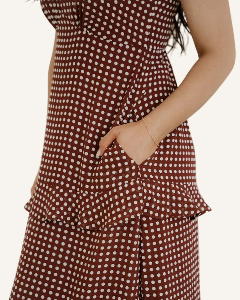 Person wearing a brown polka dot dress