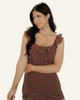 Woman wearing a brown polka dot dress. 
