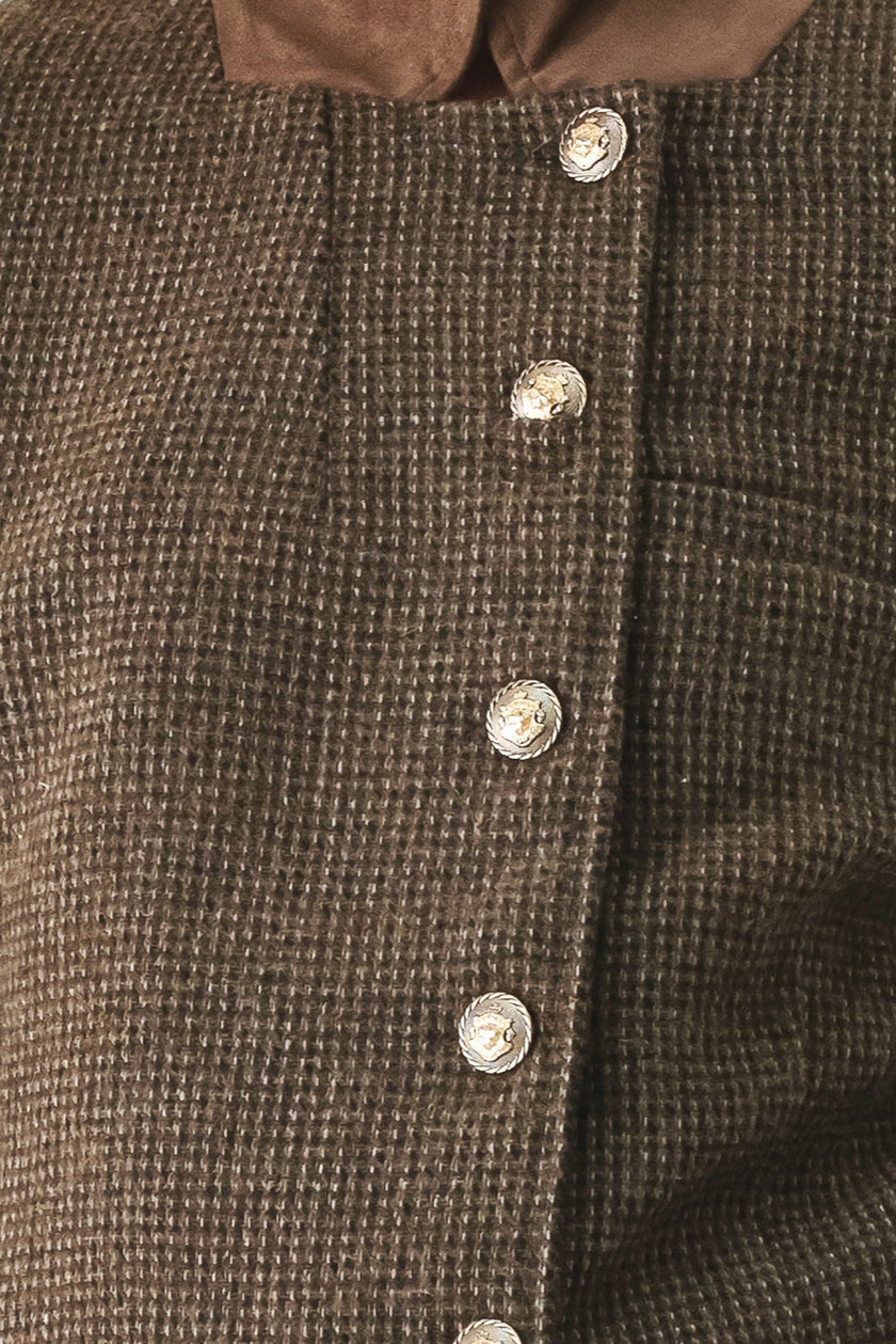 Close-up of a brown textured tweed button-up garment with a contrasting brown collar and shiny silver buttons.