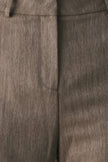 Close-up of a textured taupe-brown fabric garment, showing the weave and a central seam.