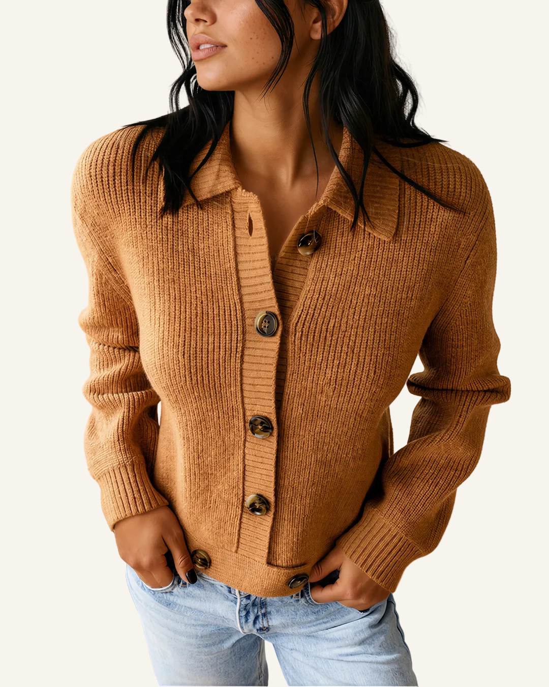 A woman wearing a ribbed knit button-front cardigan in camel brown, paired with light-wash blue jeans.