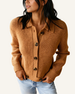 A woman wearing a ribbed knit button-front cardigan in camel brown, paired with light-wash blue jeans.